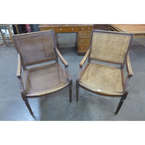 55 - A pair of French walnut bergere library chairs