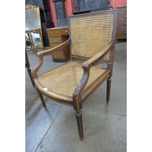 55 - A pair of French walnut bergere library chairs