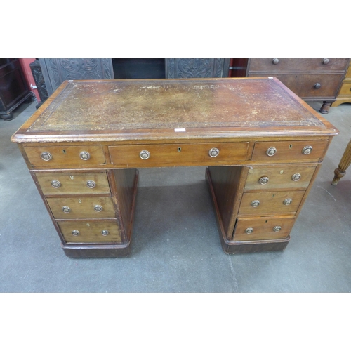 56 - A Victorian mahogany and brown leather topped pedestal desk