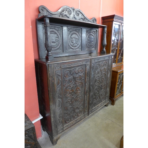 61 - A 17th Century style Flemish carved oak side cabinet