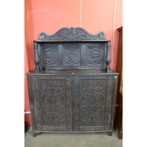 61 - A 17th Century style Flemish carved oak side cabinet