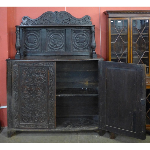 61 - A 17th Century style Flemish carved oak side cabinet