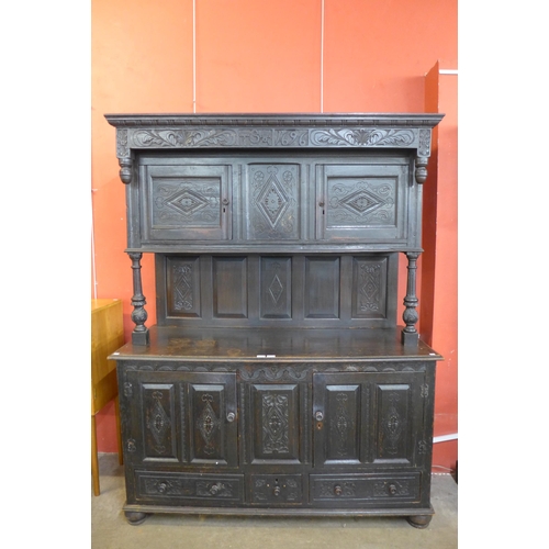 63 - A 17th Century style Welsh carved oak cwpwrdd deuddarn