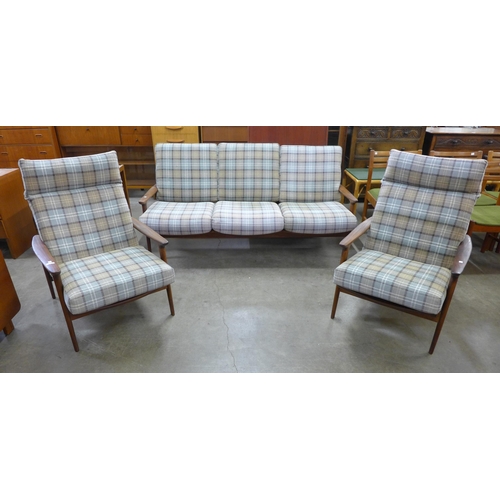 7 - A Guy Rogers teak New Yorker settee and pair of armchairs, designed by George Fejer and Eric Phamphi... 