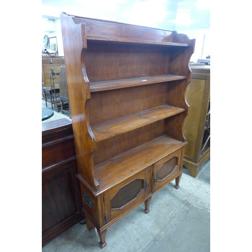 70 - An Edward VII stained pine open bookcase