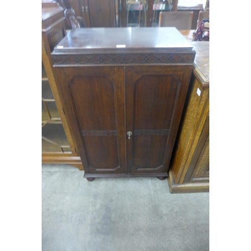 73 - An Edward VII oak fitted two door shoe cabinet