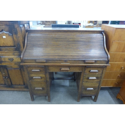 76 - An early 20th Century oak tambour roll top desk