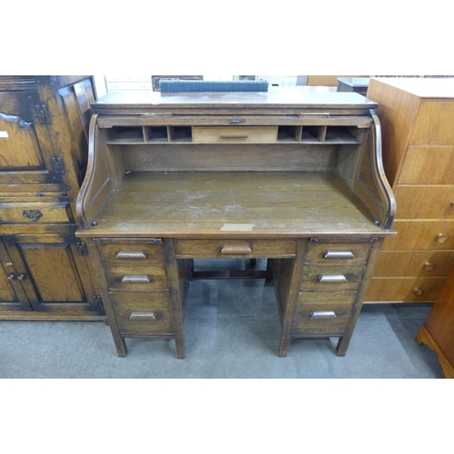 76 - An early 20th Century oak tambour roll top desk