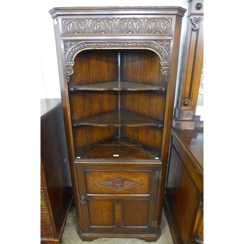 77 - A 17th Century style carved Ipswich oak freestanding corner cabinet