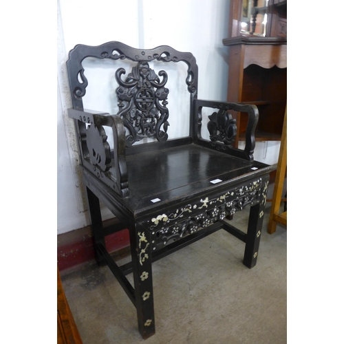 84 - A Chinese carved ebonised and mother of pearl inlaid armchair