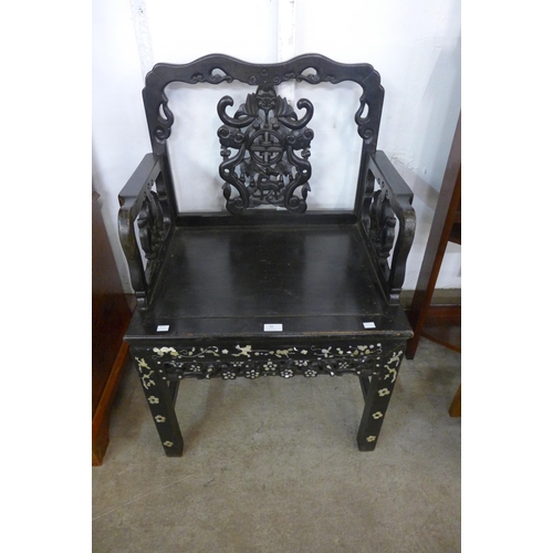 84 - A Chinese carved ebonised and mother of pearl inlaid armchair