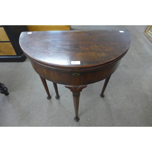 85 - A George I mahogany demi-lune fold over tea table