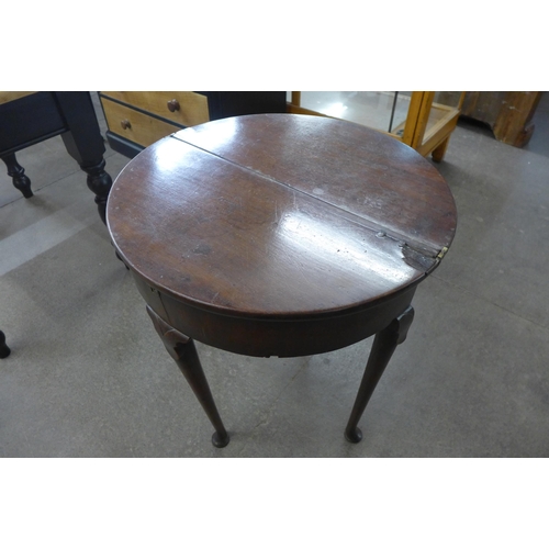 85 - A George I mahogany demi-lune fold over tea table