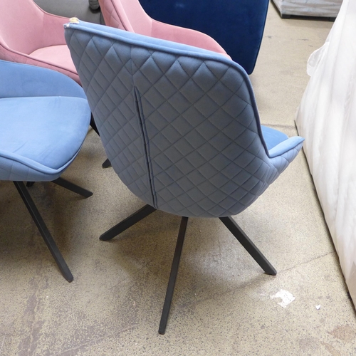 1530 - A pair of blue swivel dining chairs, one damaged * this lot is subject to VAT