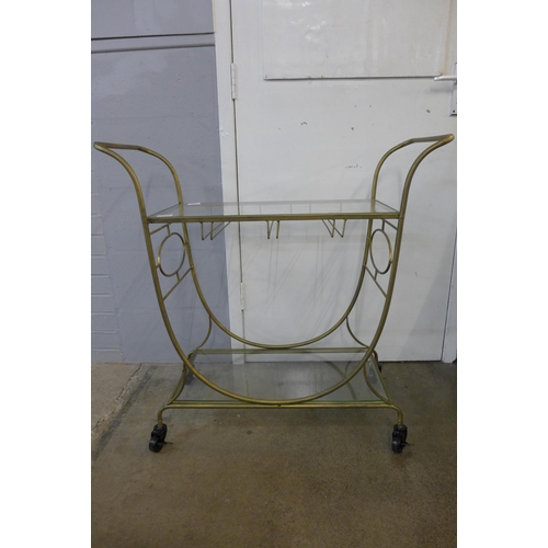 1389 - A gold metal and glass drinks trolley