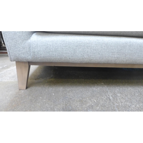 1401A - A stone upholstered three seater sofa on semi exposed hardwood frame