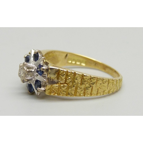 1036 - An 18ct gold cluster ring set with a diamond and blue stones, 4g, L