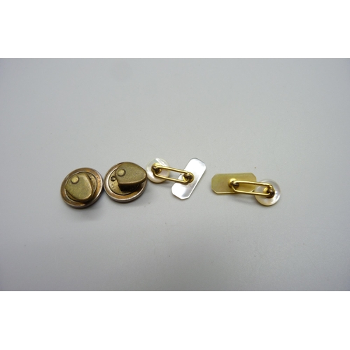 1058 - A pair of buttons and a pair of mother of pearl cufflinks