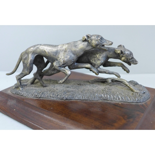 626 - A greyhound figure group on wooden base, length of base 17.5cm