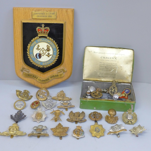 628 - A mess hall plaque and a collection of military badges