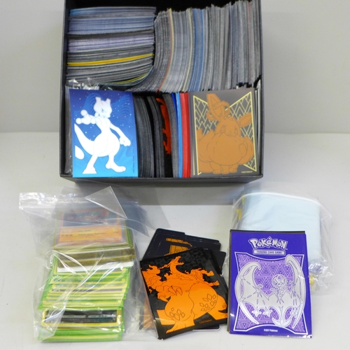 630 - Pokemon cards; 50 Holographic with large quantity of protective sleeves and 25th Anniversary box