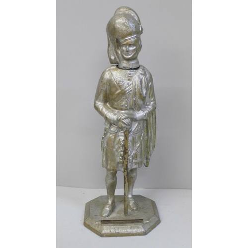 633 - A Scots Guards figural table lighter, 23cm