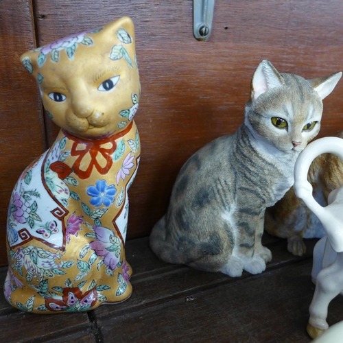 683 - A collection of cat figures including three Royal Doulton Siamese, Imari, a cream jug, Sylvac and a ... 