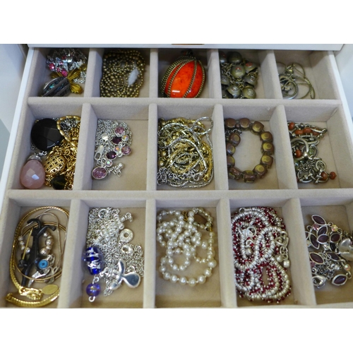 686 - A collection of cased costume jewellery including some silver