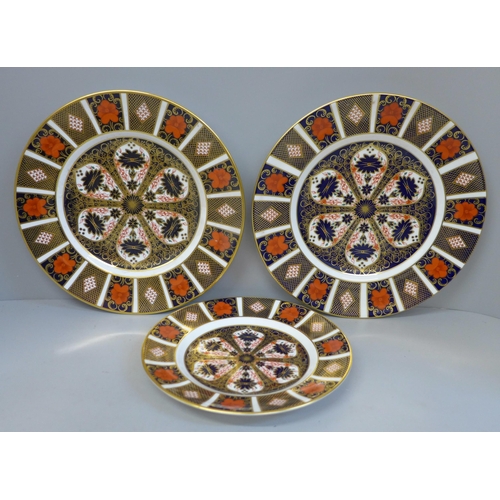 694 - A pair of Royal Crown Derby Old Imari pattern plates and a medium side plate