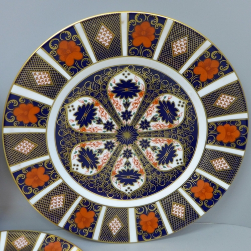 694 - A pair of Royal Crown Derby Old Imari pattern plates and a medium side plate