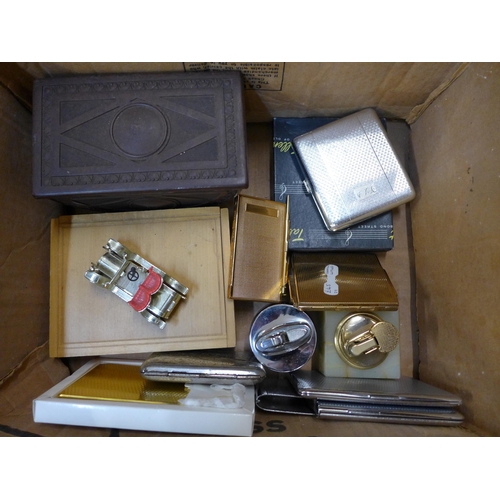 725 - A collection of smoking items including cigarette cases, tobacco box, lighters, etc.