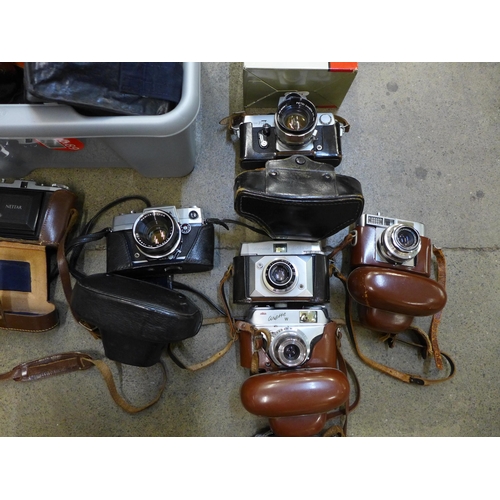 726 - A collection of cameras including Minolta, a Canon AV-1, etc.