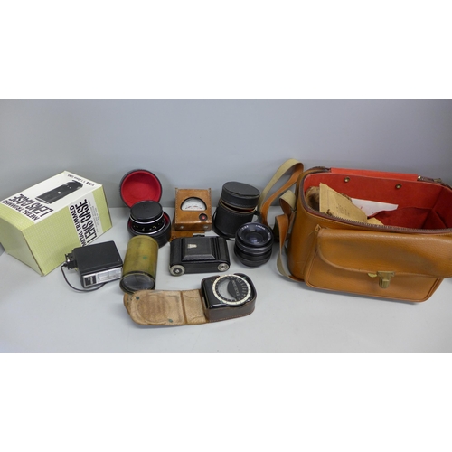 748 - A collection of camera lenses and light meters