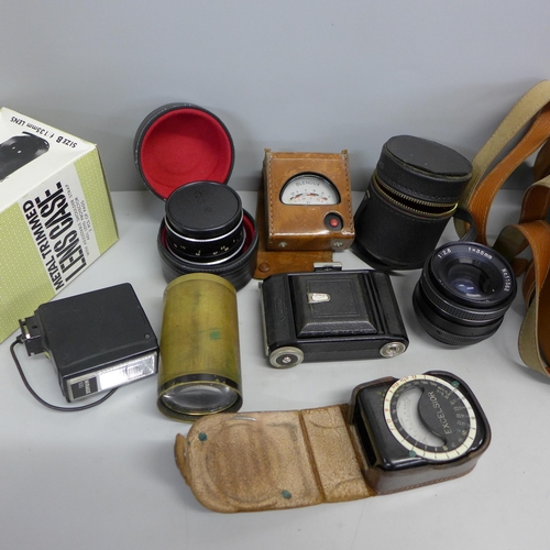 748 - A collection of camera lenses and light meters