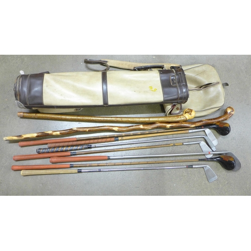 808 - Vintage golf clubs and walking sticks in a vintage golf bag