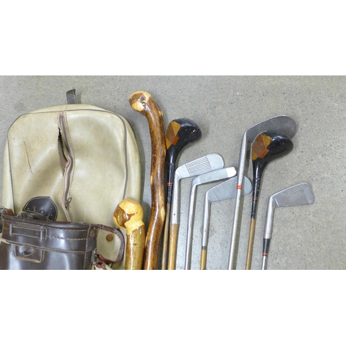 808 - Vintage golf clubs and walking sticks in a vintage golf bag