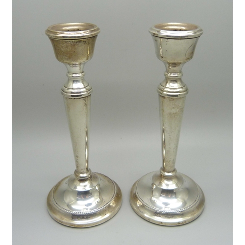 823 - A pair of silver candlesticks, 15cm