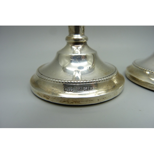 823 - A pair of silver candlesticks, 15cm