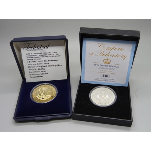 831 - Two silver coins; HRH Prince George of Cambridge first birthday commemorative coin and a gold plated... 