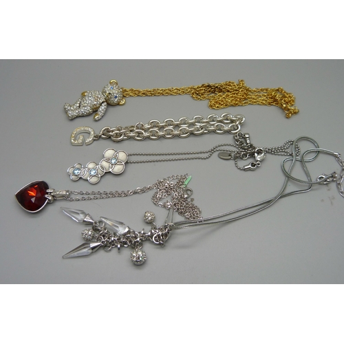 861 - A Brookes and Bentley Teddy bear necklace, two Swarovski pendants, a Swatch pendant and a Guess brac... 