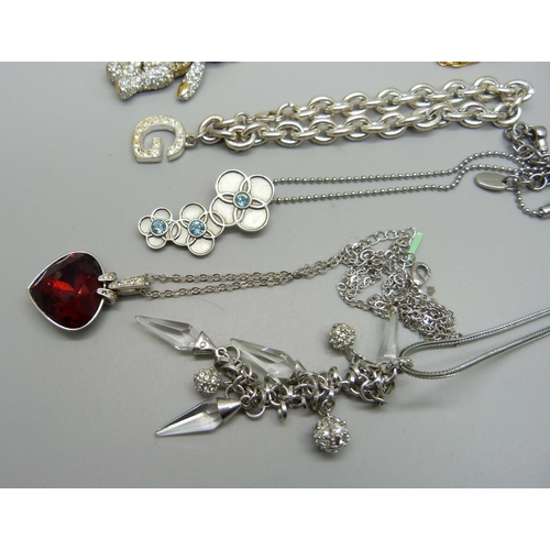 861 - A Brookes and Bentley Teddy bear necklace, two Swarovski pendants, a Swatch pendant and a Guess brac... 