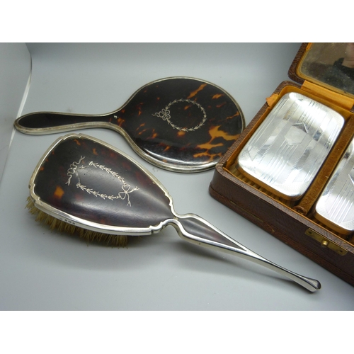 874 - A silver brush set, a silver and tortoiseshell hand mirror and a similar brush