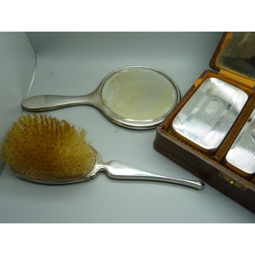 874 - A silver brush set, a silver and tortoiseshell hand mirror and a similar brush