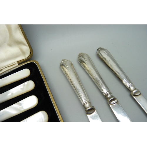 877 - A set of six silver handled knives and six mother of pearl