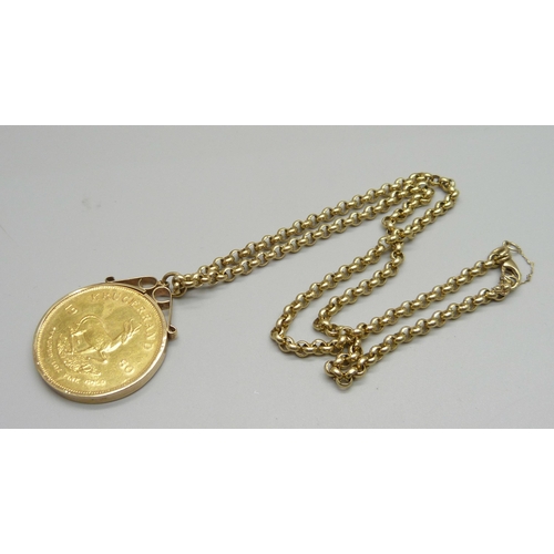 945 - A 1980 1oz. fine gold Krugerrand in a 9ct gold mount and on a 9ct gold chain, total weight 56.3g