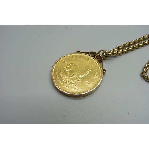 945 - A 1980 1oz. fine gold Krugerrand in a 9ct gold mount and on a 9ct gold chain, total weight 56.3g