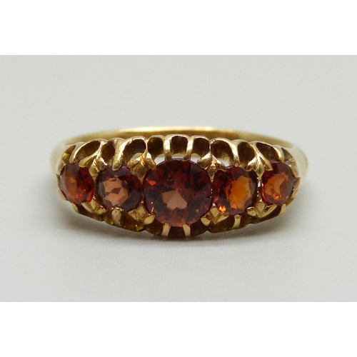 950 - An 18ct gold and red stone ring, Birmingham 1902, 4.6g, P