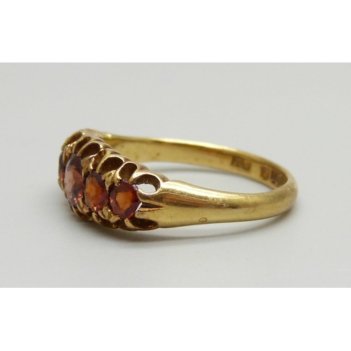 950 - An 18ct gold and red stone ring, Birmingham 1902, 4.6g, P