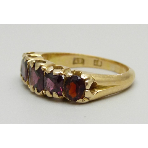 958 - An 18ct gold and red stone ring, 4.9g, L