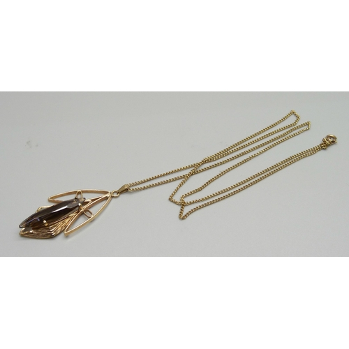 962 - A 1960's 9ct gold and smoky quartz pendant and chain, 8.4g